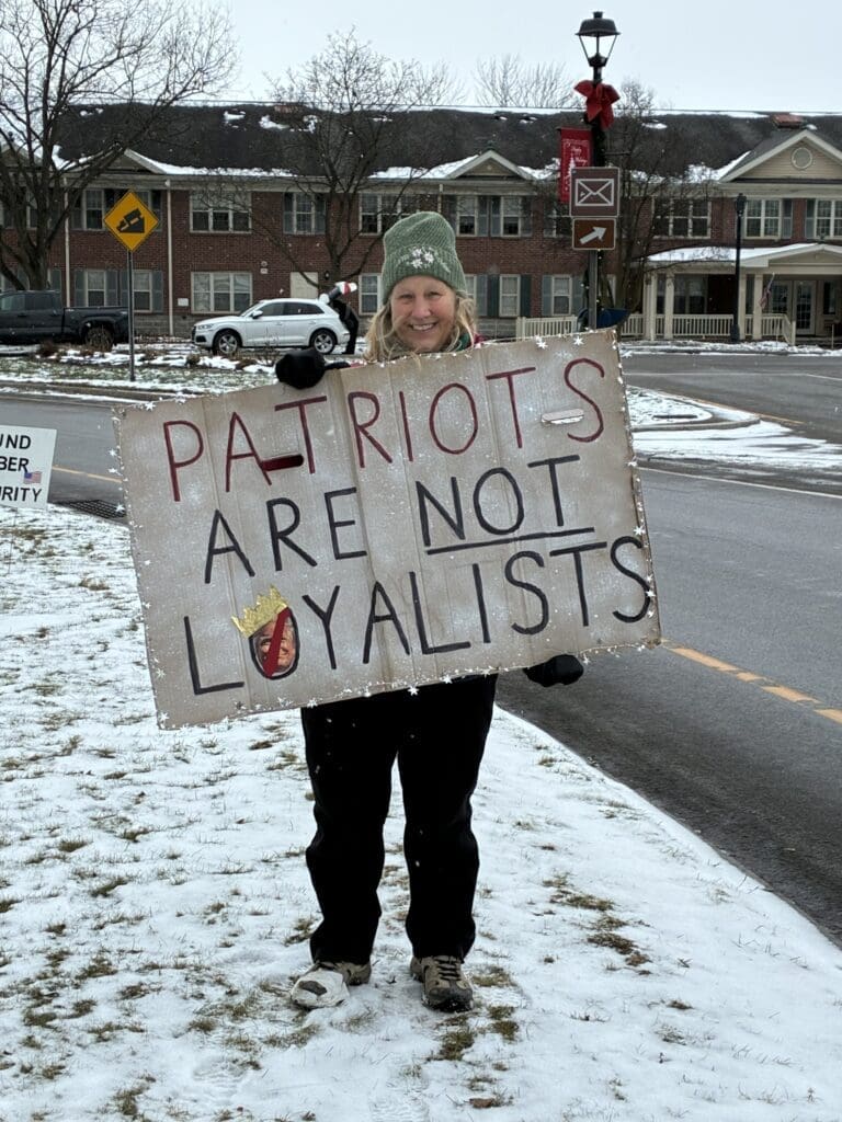 Person holds sign: Patriots are not loyalists.