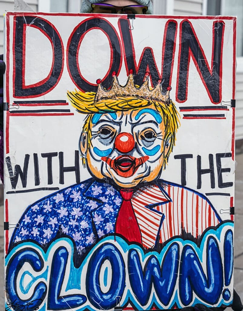 Protest sign with clown and "Down With The Clown